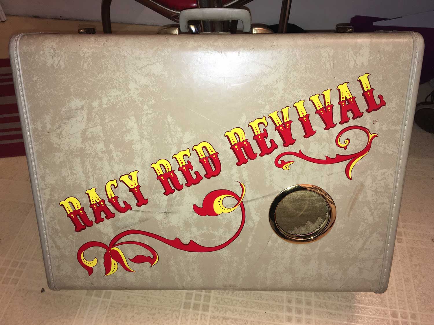 Lettering and pinstriping by Julie Fournier on a Vintage Suitcase turned into a speaker for the band Racy Red Revival